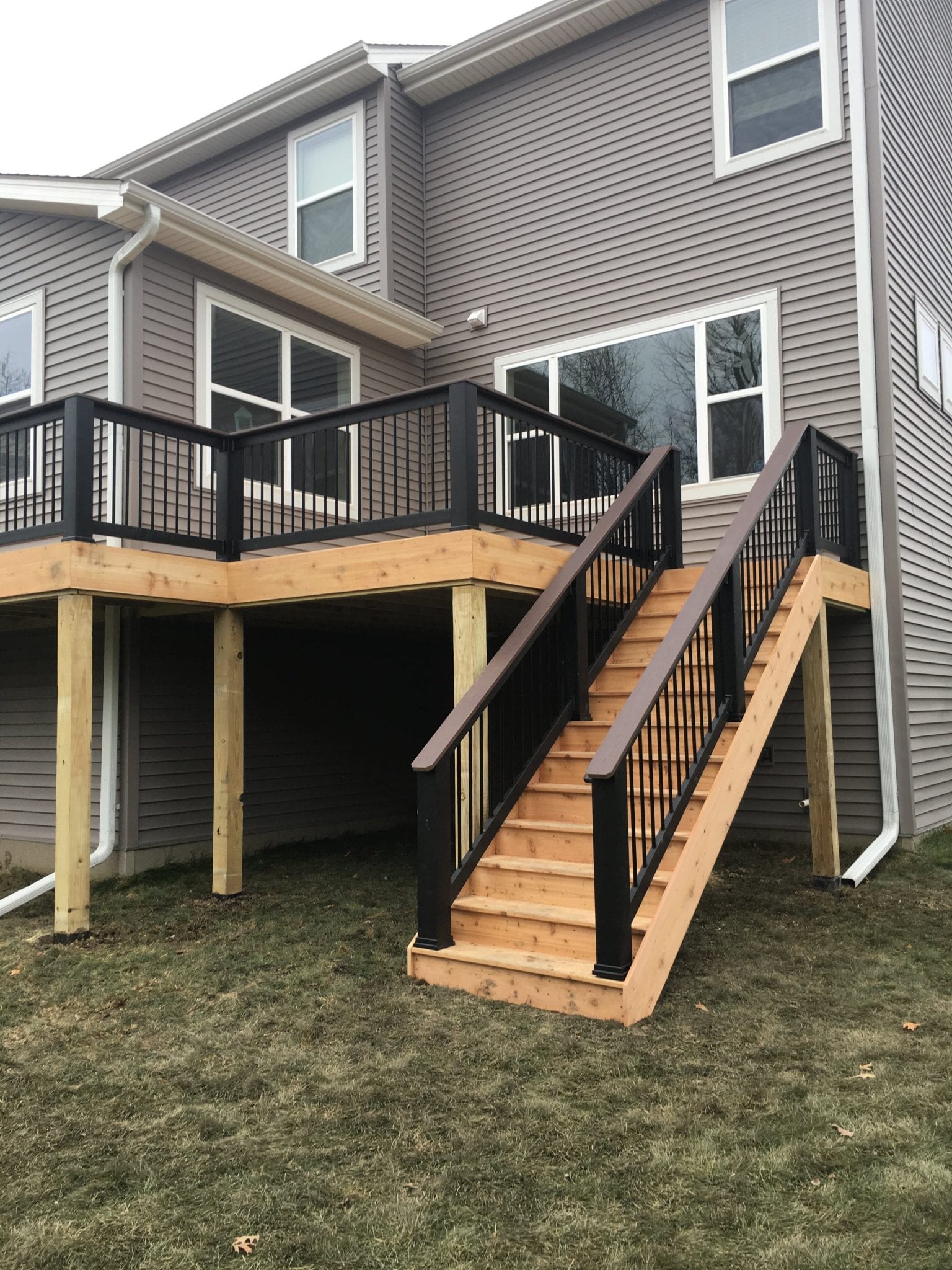 new light stained deck with black railings