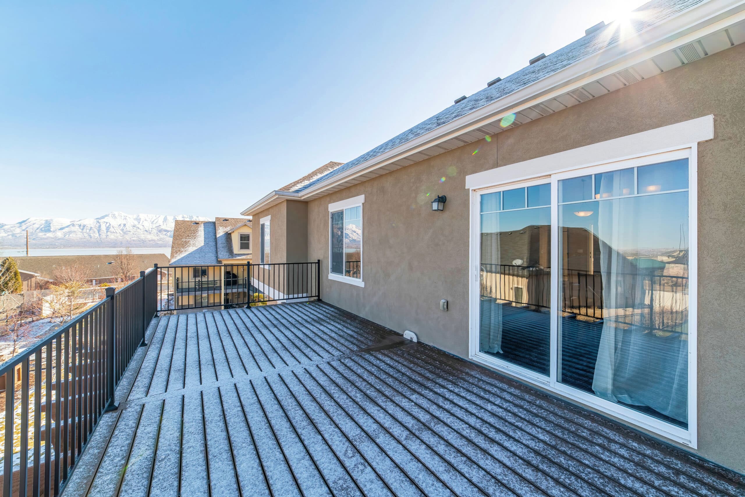 Home deck with spectacular views of lake and mountain on a sunny winter day