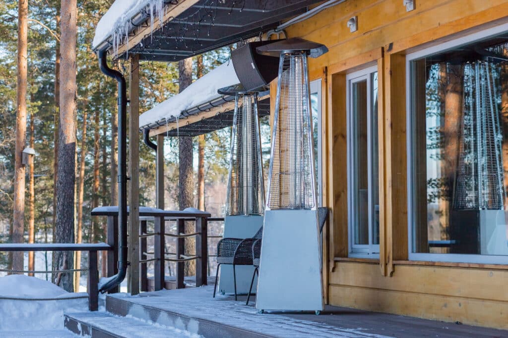 A cozy mountain modern chalet covered in snow