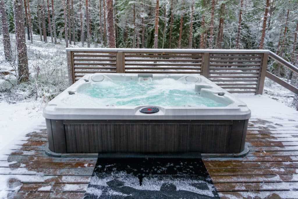 Deck Features During Winter - Modern outdoor hot tub on a wooden deck in the cold winter day